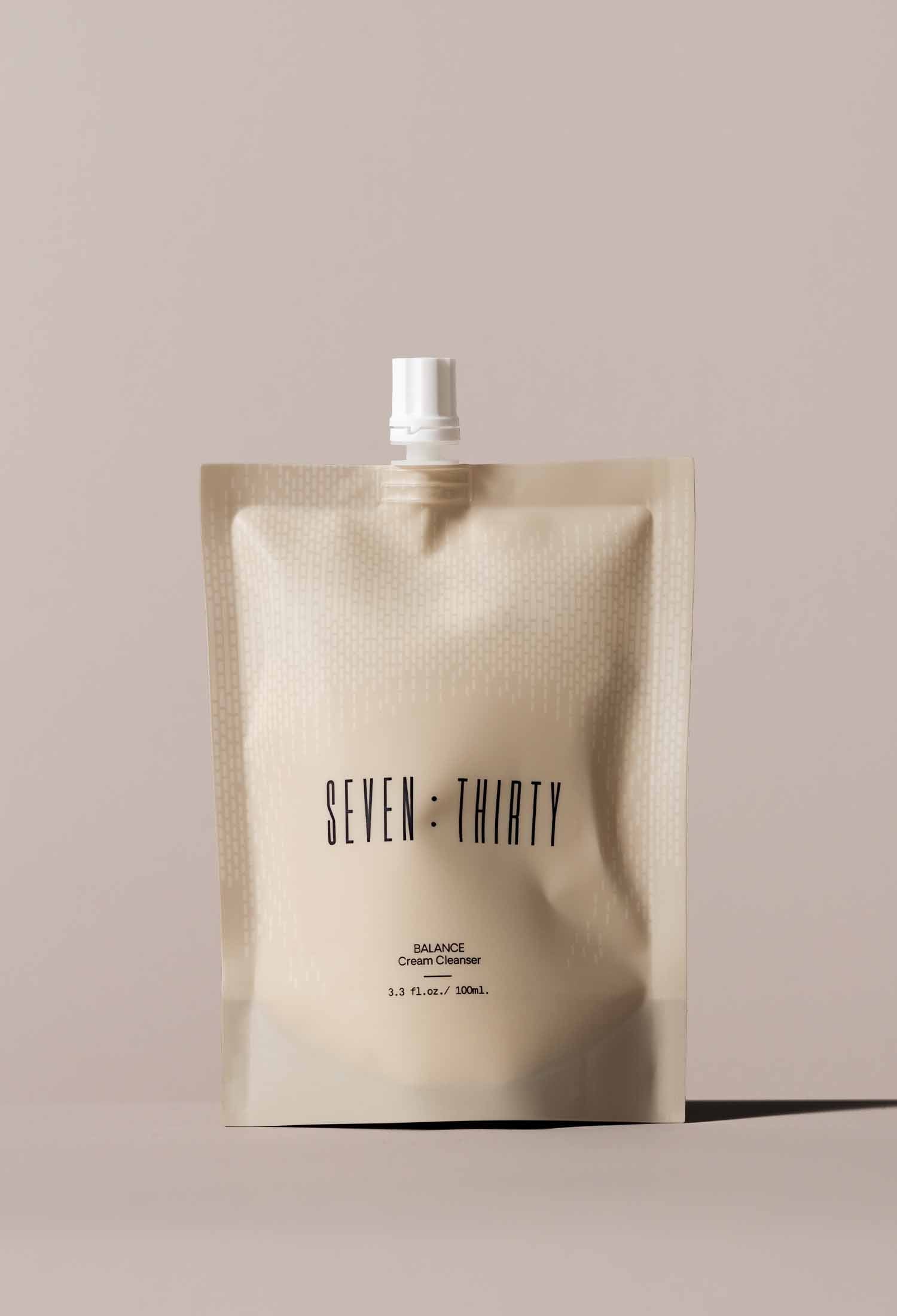 BALANCE Cream Cleanser in a khaki-colored pouch on a khaki background