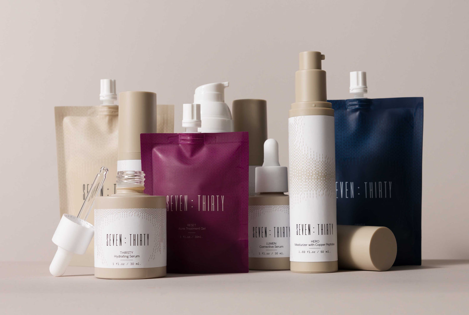 The full skincare line of products from Seven:Thirty arranged on a khaki background