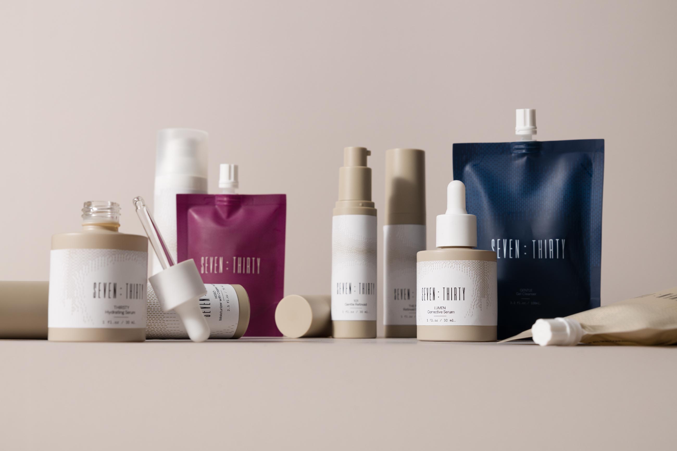The full skincare line of products from Seven:Thirty arranged on a khaki background